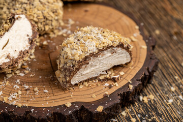 halved sweet marshmallows in chocolate sprinkled with waffle crumbs, sweet dessert marshmallows in...