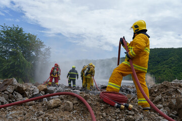 Firefighters are working together to extinguish a fire using water during a fire.