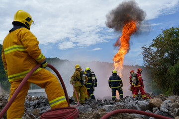 Firefighters are working together to extinguish a fire using water during a fire.