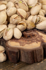 unpeeled pistachio nuts fried in salt, scattered salted pistachios after roasting with cracked shells