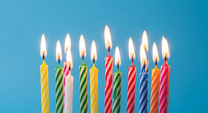 Colorful birthday candles burning brightly