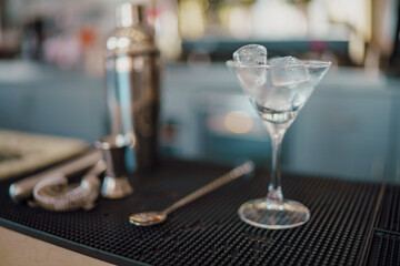 Expertly Crafted Refreshing Martini Cocktail Prepared with Ice and Essential Bartending Tools on a...