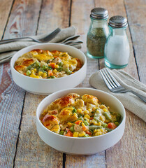 creamy chicken pot pie with onion, peas, and carrots topped with fresh thyme