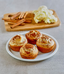 cinnamon cauliflower swirl muffins topped with lemon icing