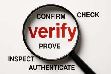 Fototapeta premium Verifying Details: A close-up shot of a magnifying glass, focusing on the word verify with supportive words around, it showcases the importance of accuracy.
