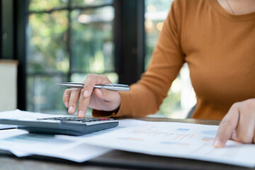 Young woman engages in note-taking at workspace.