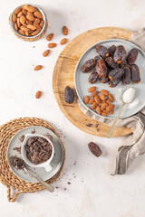 Healthy snack ingredients including medjool dates, almonds, shredded coconut, and dark chocolate...