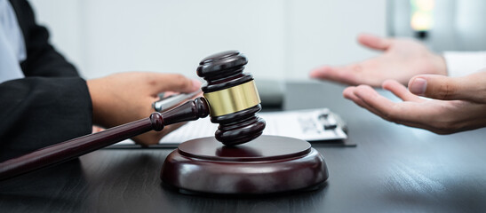 Professional Male lawyer or counselor discussing negotiation legal case with client meeting with document contract in office, law and justice, attorney, lawsuit concept