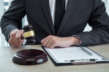 Male lawyer working with legal case document contract in office