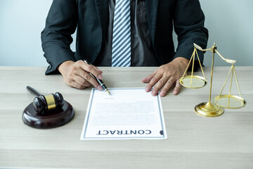 Male lawyer working with legal case document contract in office