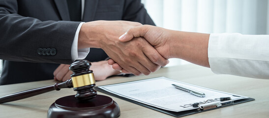 Male lawyer shaking hands with client after good deal negotiation cooperation meeting in courtroom