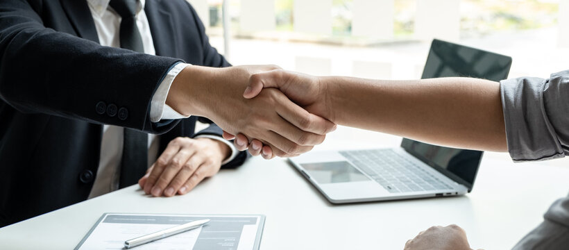 Good deal of interview, Business people and recruiter shaking hands greeting or get acquainted of conducting a job interview while sitting at the working meeting in office
