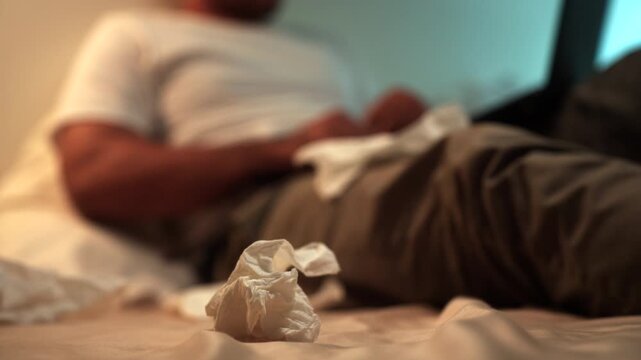 Man masturbate watching adult video on the bed with only tissues around him. Loneliness man watching porn site video on a laptop. - Powered by Adobe