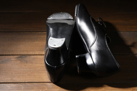 Pair of tap shoes on wooden floor, closeup. Tap dance - Powered by Adobe