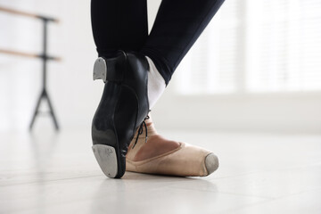 Teenage girl in tap and pointe shoe indoors, closeup