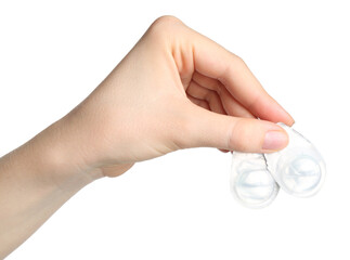 Woman holding blister packs with contact lenses on white background, closeup