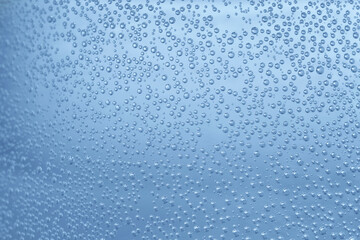 Soda water with bubbles of gas in glass, closeup