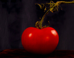 A vibrant red tomato still life with dramatic lighting, perfect for health, cooking, and nutrition...