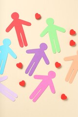 Tolerance concept. Colorful human figures and hearts on beige background, flat lay
