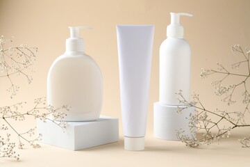 Promotion. Cosmetic products, podiums and gypsophila flowers on beige background