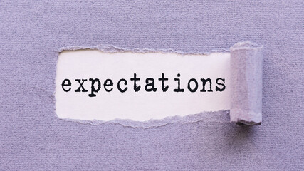 Torn Paper Revealing The Word Expectations