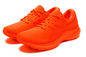 Pair of vibrant orange running shoes isolated on transparent background
