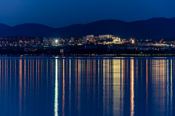 Gelendzhik resort embankment in the evening, the lamps are rhythmically reflected in Gelendzhik Bay
