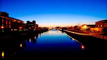 Serene Canal at Twilight with City Lights Reflecting on Water 