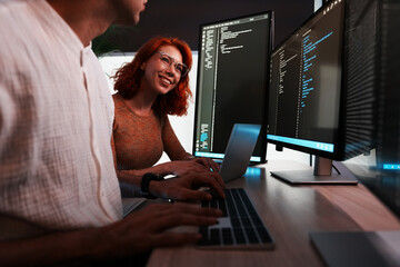female programmer is coding a hologram at night, working on data analytics, information technology,...