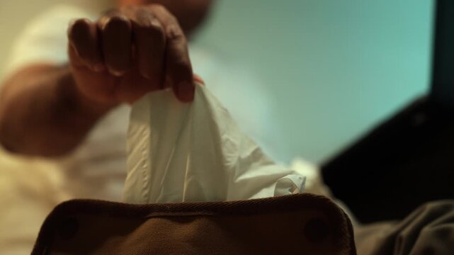 Tissues on hand Man masturbate watching adult video on the bed with only tissues around him. Loneliness man watching porn site video on a laptop.