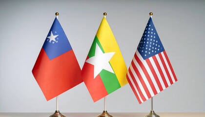 Table flags of Taiwan, Myanmar, and the United States displayed side by side with gold finials, representing diplomatic presence and international diversity.