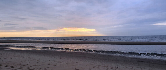 Fototapeta premium Vacation by the sea at sunset. Sea, sky, sand on the beach.