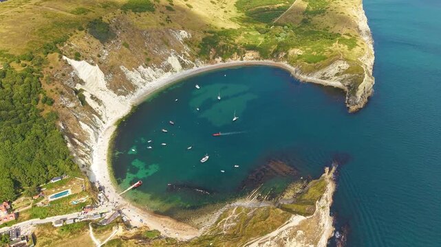 Downward panning drone footage of famous Lulworth Cove on the Jurassic Coast, Dorset