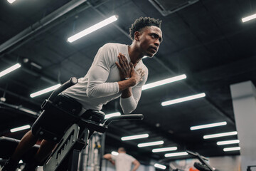 Determined athlete performing roman chair back extension exercise in gym