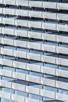 Close view of repeating glass balconies, forming abstract patterns and reflecting minimal design principles that define modern residential living and contemporary urban architecture
