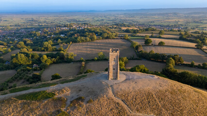 Aerial photograph of the pathway climbing Glastonbury Tor, leading up to St Michael’s Tower. Captured just after sunrise, this image highlights the mystique and beauty of Somerset’s most famous landma © Jez