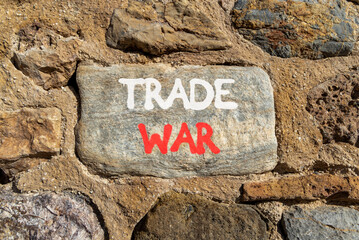 Trade war symbol. Concept word Trade war on beautiful grey stone on stone wall. Beautiful stone...
