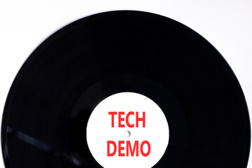 Tech demo symbol. Concept word Tech demo on beautiful black and white vinyl disk. Beautiful white...