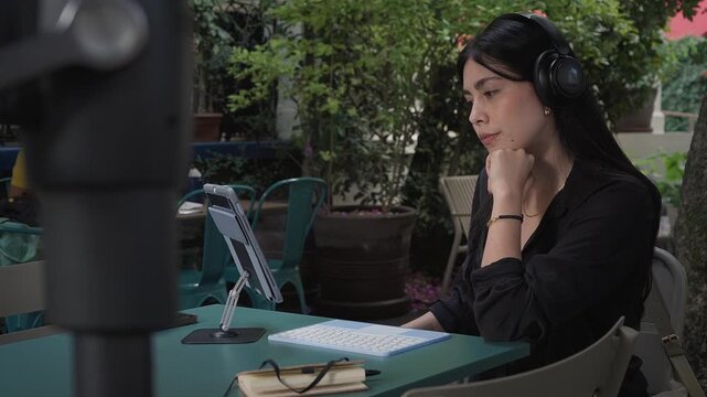 Professional female therapist sitting outdoors, engaging in compassionate mental health video call, supporting client with empathetic counseling during digital telehealth session