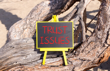 Trust issues symbol. Concept word Trust issues on beautiful black blackboard. Beautiful old tree...