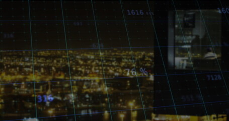 Displaying nighttime riverfront skyline through data grid overlay, with computer monitor inset