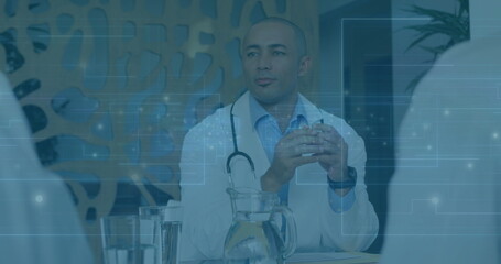 Joining doctor wearing lab coat with stethoscope consulting during medical meeting, with paperwork