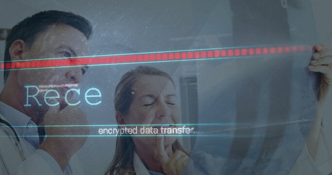 Senior doctors in white coats studying X-ray film in exam room, with stethoscope and data overlay