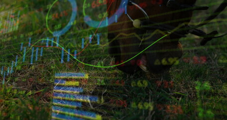 Standing riding boot with metal spur on grass, with financial graphs overlay, copy space