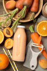 Superfood. Tasty smoothie in bottle and ingredients on wooden table, flat lay