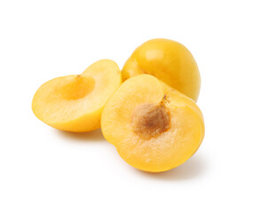 Whole and cut yellow cherry plums isolated on white