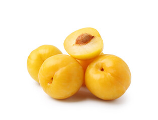 Whole and cut yellow cherry plums isolated on white
