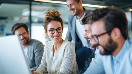 Obraz premium A group of five employees collaborates in a sleek office environment, sharing ideas and smiling while working together on a project at a daytime brainstorming session.