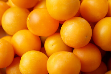 Ripe yellow cherry plums as background, closeup