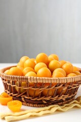 Ripe yellow cherry plums on white wooden table, closeup. Space for text
